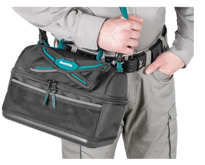 Person wearing a grey tool bag with a prominent Makita logo.